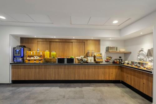 a kitchen with a counter with food on it at City Express by Marriott Guadalajara Aeropuerto in Guadalajara
