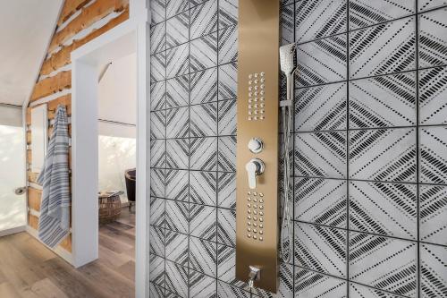 a hallway with a black and white patterned wall at Oak Retreat Glamping With Private Hot tub in Luckenbach