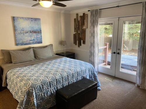 a bedroom with a bed and a sliding glass door at Wasatch Front home with pool close to everything! in Murray