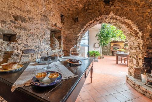 a stone kitchen with a counter with bowls of food on it at Antico Convento - Ospitalità Diffusa in Rocca Cilento