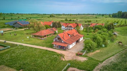een luchtzicht op een huis met rode daken bij Siedlisko Nawiady - hotel butikowy in Nawiady