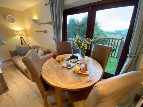 a dining room with a wooden table and chairs at Lune Cottage nestled between Lake District and Yorkshire Dales in Tebay