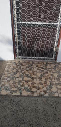 a room with a window with a stone floor at Jetpoint Furnished 2 bedroom in Nadi