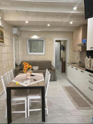 a kitchen and dining room with a table and chairs at Casa Vacanza Al Duomo in Barletta