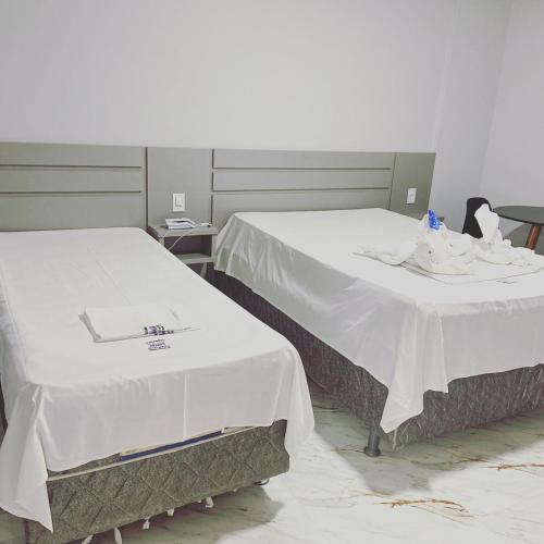 Tempat tidur dalam kamar di Caldas Novas - Araras Apart Service