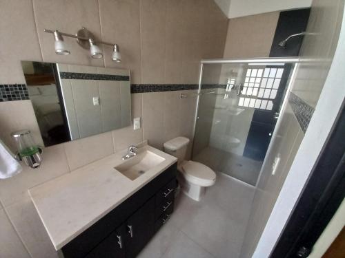 ein Bad mit einem Waschbecken, einem WC und einer Dusche in der Unterkunft Casa Tastuán in Tonalá
