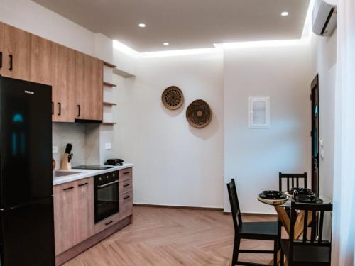 Una cocina con un refrigerador negro y una mesa. en Syvota Apartments Cozy, en Sivota
