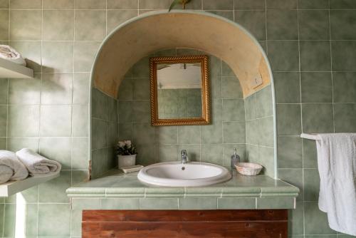 a bathroom with a sink and a mirror at Antico Convento - Ospitalità Diffusa in Rocca Cilento