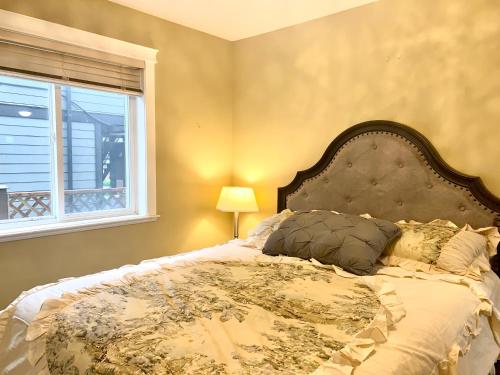 a bedroom with a large bed with a window at Angel 3D in Victoria