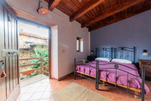 a bedroom with a bed and a balcony at Antico Convento - Ospitalità Diffusa in Rocca Cilento