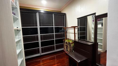 a room with black glass shelves and a staircase at YB Guest House 4 Bilik 5 Katil in Cukai