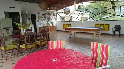a dining room with a ping pong table and chairs at Finca Maratón Alto in Calarcá