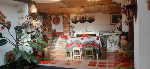 a kitchen with a table and chairs in a room at D'Antaño in Duitama