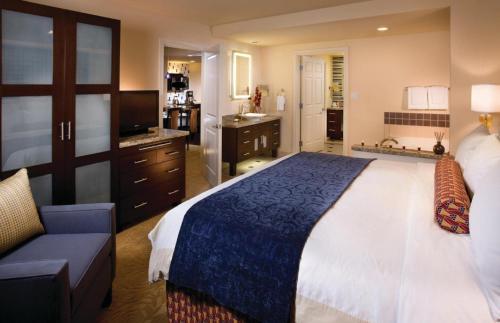 a bedroom with a large bed and a bathroom at Marriott's Grand Chateau in Las Vegas