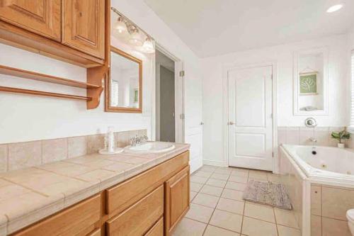 a bathroom with a sink and a tub and a toilet at Wilson Family Retreat in Blackfoot