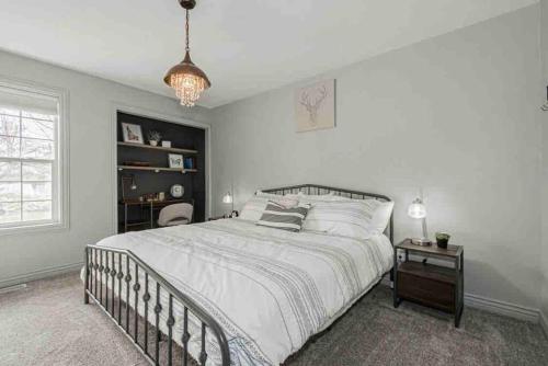 a bedroom with a large bed and a chandelier at Wilson Family Retreat in Blackfoot