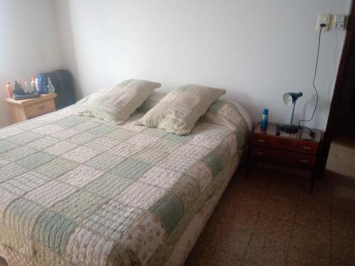 Un dormitorio con una cama con dos almohadas encima. en Lo de Pedro Tandil, en Tandil