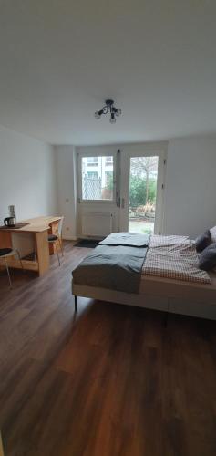 a bedroom with a bed and a desk and a table at Stube 21 in Weingarten