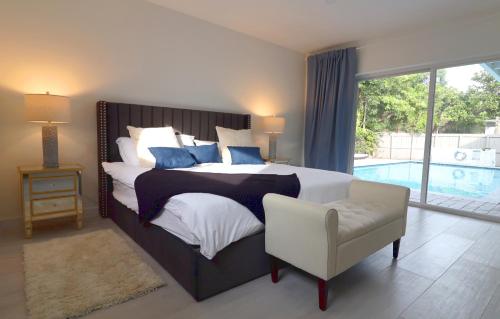 een slaapkamer met een bed en een stoel en een zwembad bij Villa Cristina in Miami in Miami
