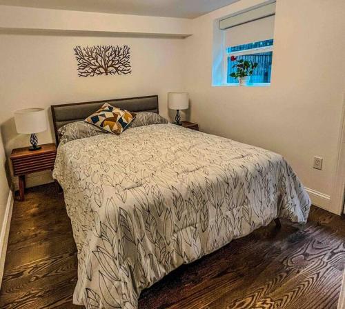 a bedroom with a bed and two lamps and a window at Cozy NYC Apt, Carroll Gardens - long & short-term in Brooklyn