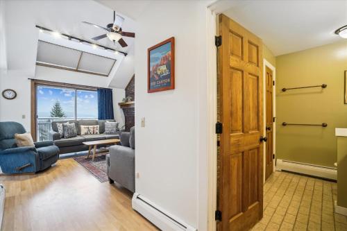 a hallway of a living room with a door at Sunrise Village East Glade B2: Ski in/ski out right from your 3 bedroom condo in Killington