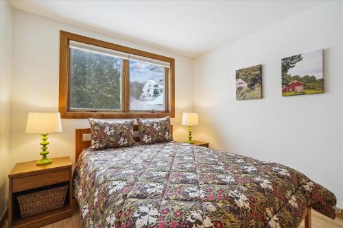 a bedroom with a bed and a window at Sunrise Village East Glade B2: Ski in/ski out right from your 3 bedroom condo in Killington