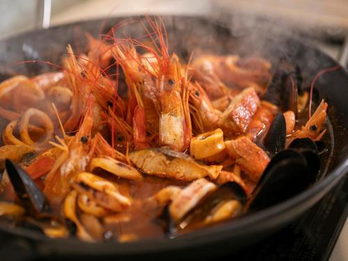 a bunch of food in a pan on a stove at KAMENOI HOTEL Atami in Atami