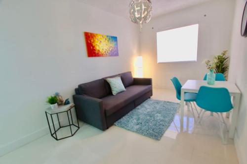 a living room with a couch and a table at Modern 1/1, Half a Block from The Ocean in Miami Beach