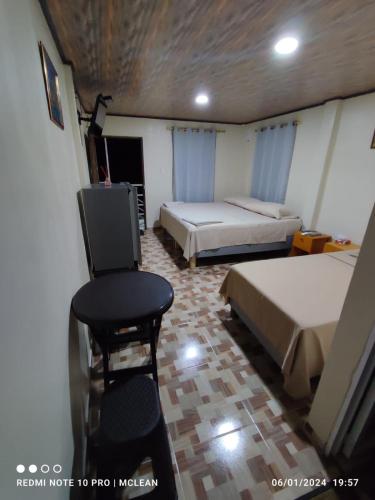 a room with two beds and a chair in it at POSADA BLUE WAVE VIEW in Archibolds