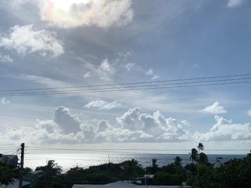a view of the ocean with clouds in the sky at POSADA BLUE WAVE VIEW in Archibolds