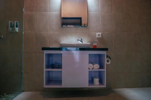 a bathroom with a sink and a counter with towels at Sawit Garden Cottages in Nusa Penida