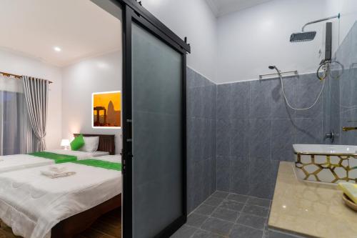 a bedroom with a shower and a bed and a bathroom at The Khmer house Villas in Siem Reap