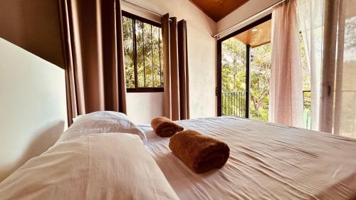 a bedroom with a bed with two teddy bears on it at Casa Encantada offers you Two-Bedroom House, 1 Tiny Apartment & 3 Double Rooms in Manuel Antonio