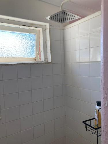 a bathroom with a white tiled shower with a window at Yealering Hotel in Yealering