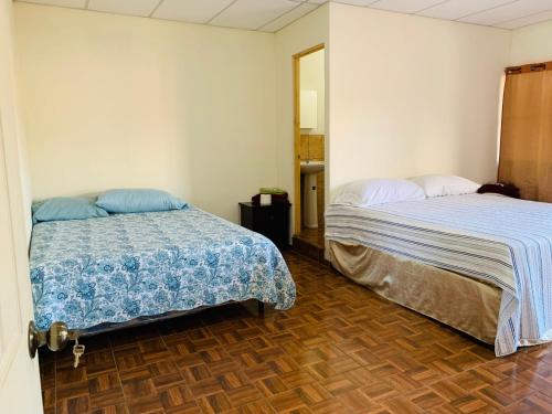 a bedroom with two beds and a mirror at Sucursal del Cielo in Concepción de Ataco