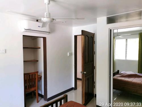 een kamer met een deur, een bed en een spiegel bij Tropicasa Siquijor Seafront Guest House in Solangon