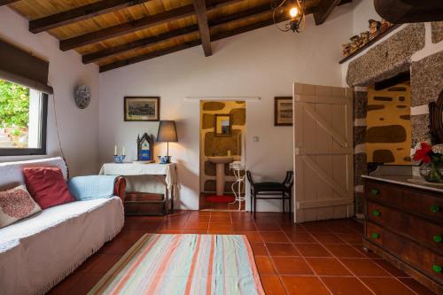 a living room with a couch and a bedroom at 1720 Quinta da Cancela - Winery & Farmhouse in Guimarães