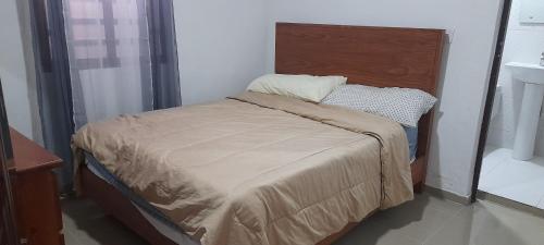 ein kleines Bett in einem Zimmer mit einem Kopfteil aus Holz in der Unterkunft VILLA JMB in Constanza