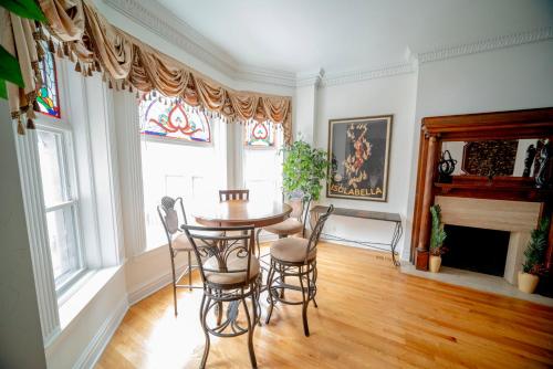 a dining room with a table and chairs and a fireplace at Club Salon Sleeps 10-20 Free Parking & TV in Chicago
