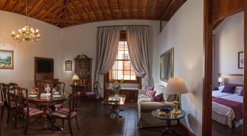 a living room with a bed and a dining room at MC San Agustín in Las Lagunas