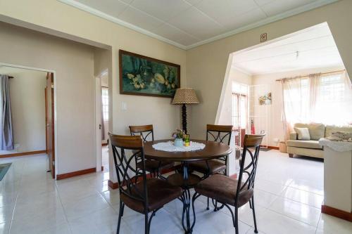 a dining room with a table and chairs at Paddock Road in Bridgetown