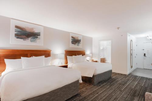 a hotel room with two beds and a bathroom at TownePlace Suites Stafford in Stafford