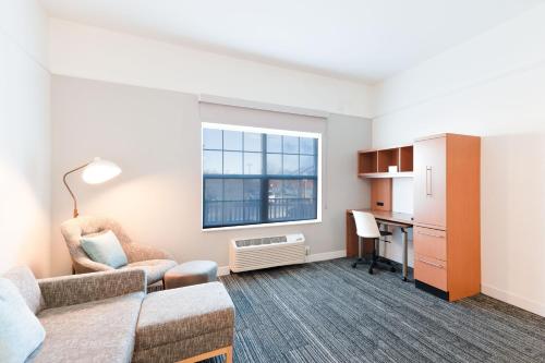 a living room with a couch and a desk at TownePlace Suites Stafford in Stafford