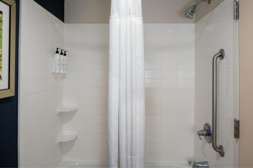 a shower with a shower curtain in a bathroom at Fairfield Inn and Suites Memphis Germantown in Memphis