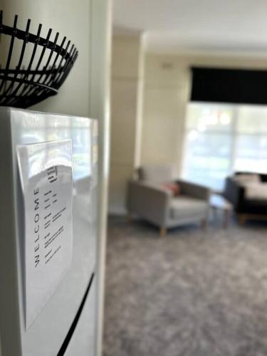 a refrigerator in a room with a living room at Shepparton House in Shepparton