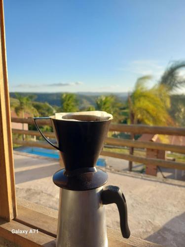 a coffee maker sitting on top of a window at Chacara em Condomínio in Mairinque