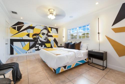 a bedroom with a large bed with a painting on the wall at Le Femme Paradise in Miami