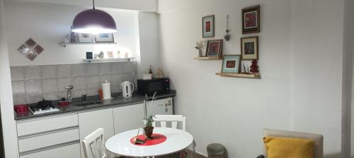 a kitchen with a small table and a kitchen counter at Espacio B in Chivilcoy