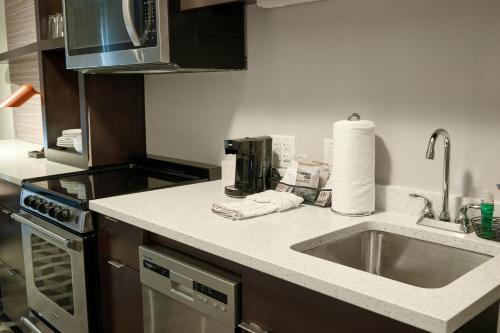 a kitchen counter with a sink and a microwave at TownePlace Suites By Marriott Columbia West/Lexington in West Columbia