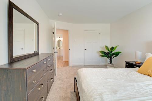 a bedroom with a dresser with a mirror on it at Cozy Luxury Living in Auburn, Your Stylish Escape - 2BD 1BA Apartment, Free Parking, WiFi & Balcony! in Auburn